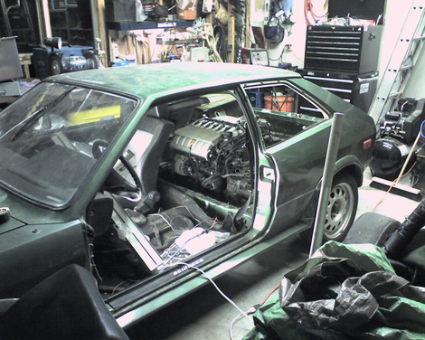 Testing the fit of the car’s new engine.